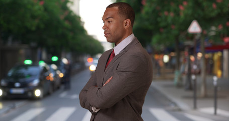 Aspiring African-American professional in city street with arms crossed