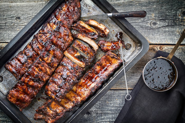 Barbecue spare ribs St Louis cut with hot honey chili marinade as top view in a rustic skillet - obrazy, fototapety, plakaty