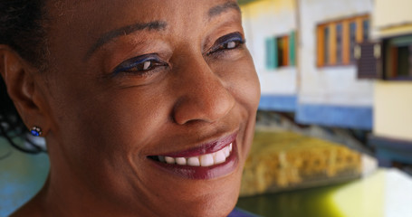Close up of elderly black woman smiling into the distance