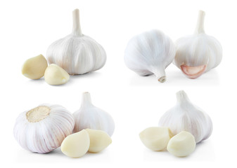 Set of different garlic bulbs and cloves on white background
