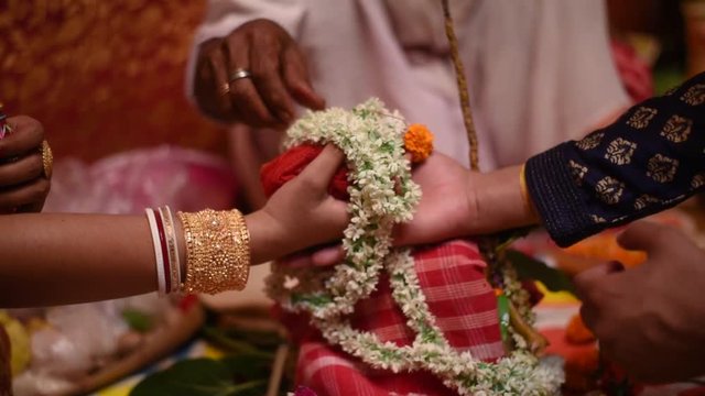 Colorful Bengali Indian Wedding with hands joined of bride and groom camera track left to right