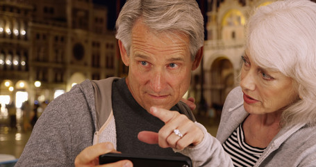 Mature couple arguing about directions in Venice
