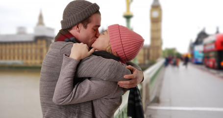 Happy Caucasian couple on Westminster Bridge looking into each others eyes 