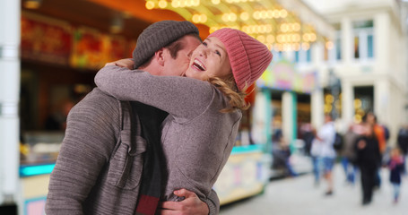 Fototapeta premium Happy Caucasian couple outdoors in winter clothes smiling and being affectionate