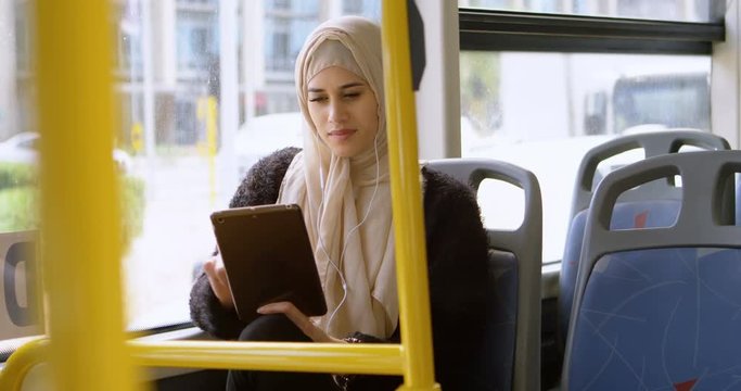 Woman in hijab using digital tablet 4k