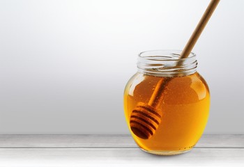 Fresh sweet honey with wooden honey dipper