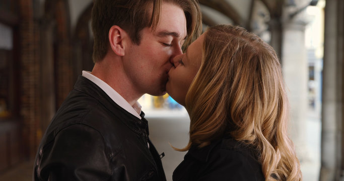 Millennial couple share sweet kiss