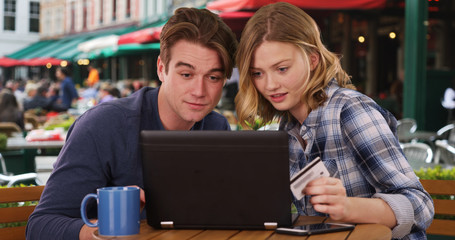 Happy Caucasian man and woman shopping online with computer
