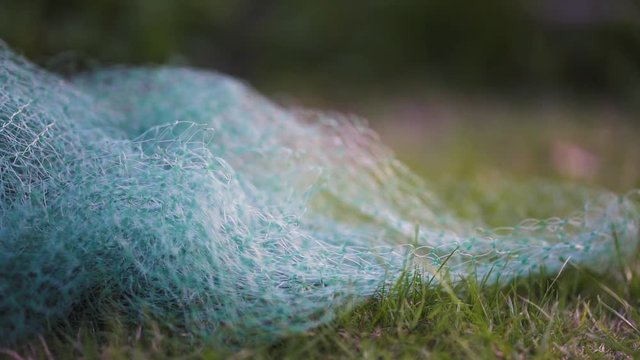 Blueish small nit net on grass. slow motion.