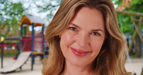 Obraz premium Close up of Caucasian woman with bright smile outside at park