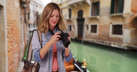 Travel photographer in Venice taking picture outside smiling