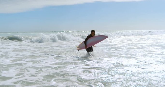 Woman with surfboard running on the sea 4k