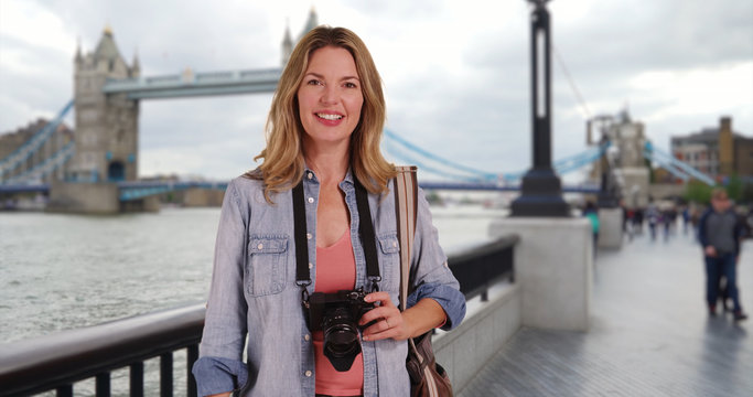 Travel photographer standing in front of Tower Bridge in London UK