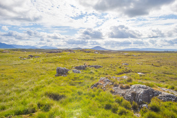 Fototapeta na wymiar Panorama of mountains, marshy land and heathland of Connemara National Park in summer