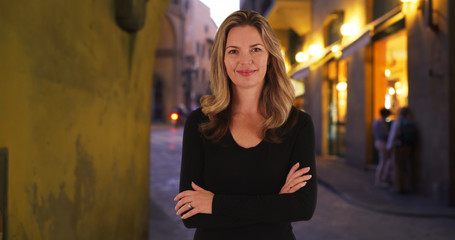 Casual portrait of beautiful Caucasian woman outside at night in Florence