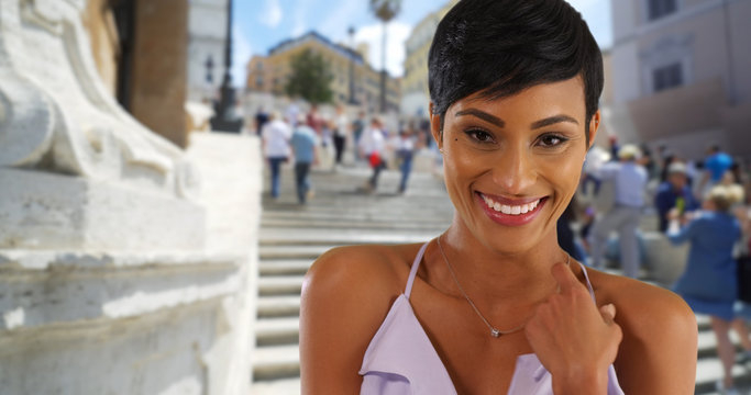 Closeup portrait of beautiful young black woman in Rome Italy happy and excited