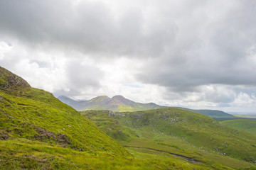 Obraz na płótnie Canvas Panorama of mountains, marshy land and heathland of Connemara National Park in summer