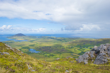 Obraz na płótnie Canvas Panorama of mountains, marshy land and heathland of Connemara National Park in summer