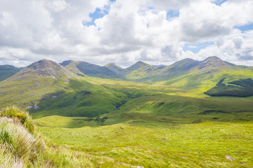 Panorama of mountains, marshy land and heathland of Connemara National Park in summer