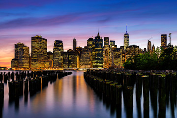 Fototapeta na wymiar Lower Manhattan skyline view from Brooklyn Bridge Park waterfront at sunset