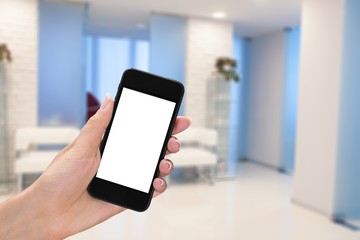 Hand holding smartphone on blurred background