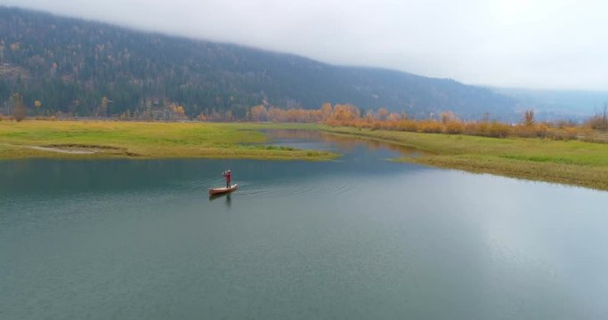 Man rowing a boat on a lake 4k