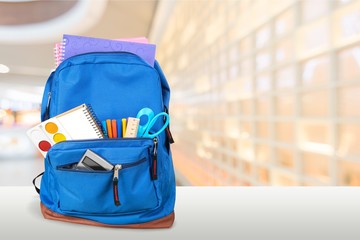 Colorful school supplies in backpack