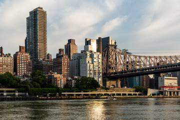 Fototapeta na wymiar New York City / USA - JUL 31 2018: Queensboro Bridge and midtown view from Roosevelt Island in the early morning