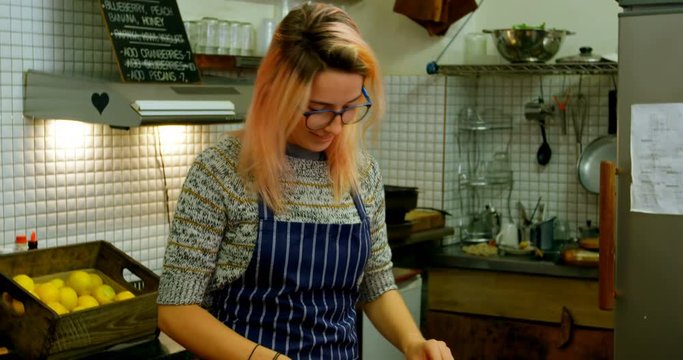 Woman chopping vegetables in cafe kitchen 4k