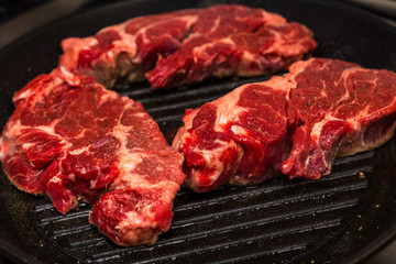 Three Chuck Steaks on Skillet