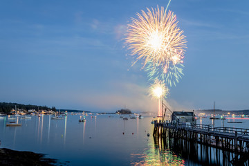 Fireworks on Boothbay Harbor, Maine, reflect off the water on July 4th for Independence Day celebration
