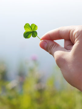 Four-leafed clover in hand.