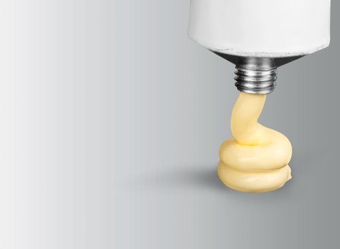 Tube of toothpaste on gray background