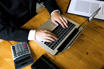 Businessman using laptop to the situation on the market value , Business concept