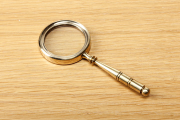 gold magnifier on the wood table