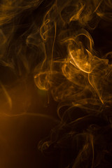 Gold smoke on black background.
