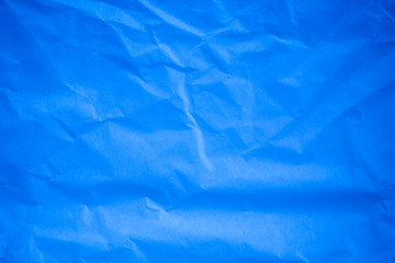 Obraz premium Crumpled blue paper background.