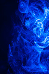 Blue smoke on black background.