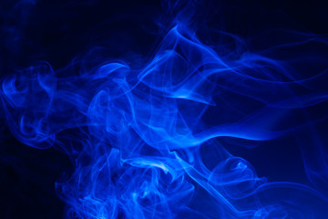 Blue smoke on black background.