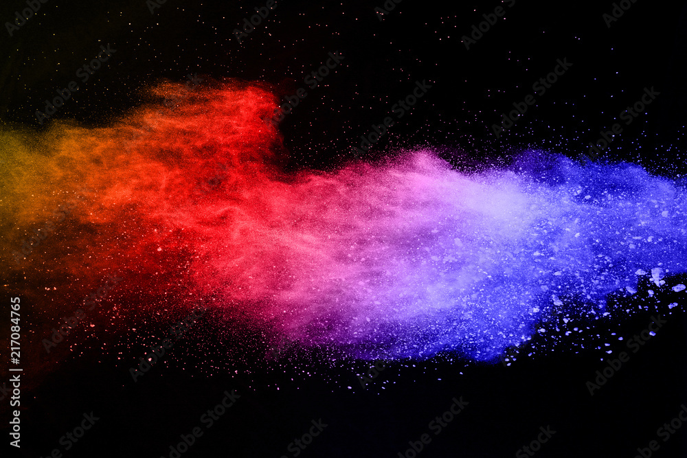 Wall mural abstract colored dust explosion on a black background.abstract powder splatted background,Freeze motion of color powder exploding/throwing color powder, multicolored glitter texture.