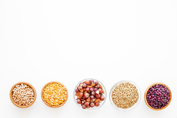 Obraz na płótnie Canvas Vegan protein source. Legumes and nuts on white background top view copy space
