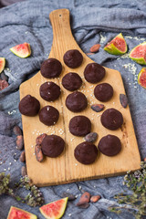 Chocolate truffle confectionary made with grated chocolate, cocoa or carob powder, coconut oil, chopped nuts, sweet nuts. Healthy vegan sweets or vegetarian sweets.