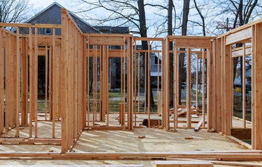New residential construction house framing against a blue sky.