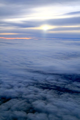 Sunset Over Sea of Clouds and Horizon line from a Plane.