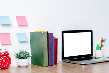 Office desk mockup concept.Mockup modern desktop with blank screen laptop computer and a lot of things on white background.Blank screen laptop computer for products display montage.