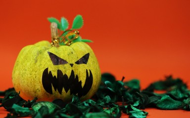 Halloween pumpkin scary face decoration closeup orange texture blur background