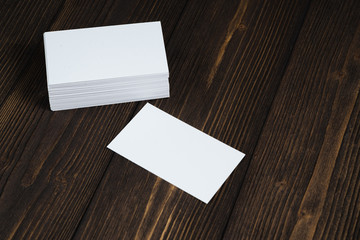 Blank business cards on wooden working table with copy space for add text ID. and logo, business company concept.