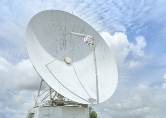 Big large white satellite dish turn up skyward on blue sky in earth communication antenna system...