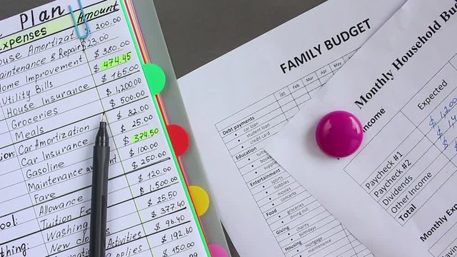 Family budget. Monthly expenses list. Woman writes down all her sources of income and all your expenses