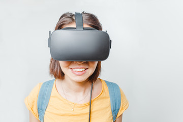 Young woman using a virtual reality headset at white background